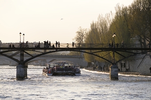 Tourist boat passing under Pont des Arts. Paris by Kevin Oke