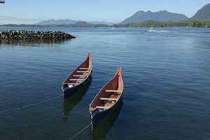 Two native canoes anchored in Tofino Harbour by Kevin Oke