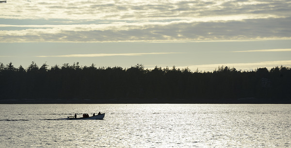 Backlit small boat coming into Tofino Print