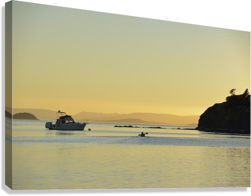 Kayaker and motor boat at anchor in Fox Cove. Sucia Island Canvas Print