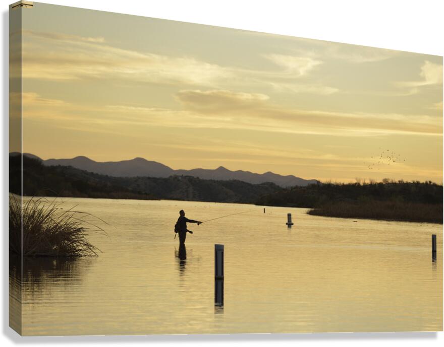 Backlit man fishing at sunset Patagonia Lake State Park Arizona USA Canvas Print