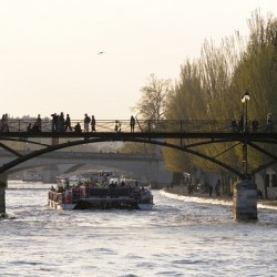 Tourist boat passing under Pont des Arts. Paris