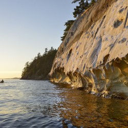 Sea kayaking under the sculpted sandstone cliffs