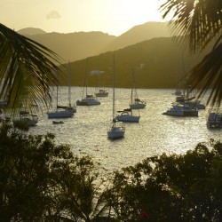 Catamarans and sailboats at the anchorage at Pussers Marina Cay