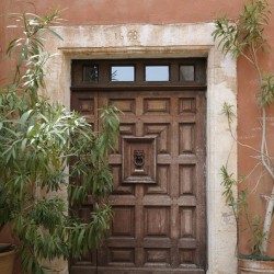 Wooden door with door knocker. Roussillon. France