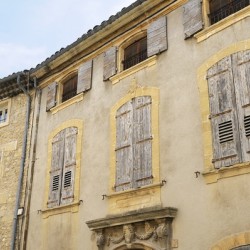 Shuttered windows on an old apartment  building in Lourmarin