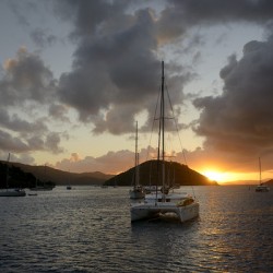 Caribbean sunset with catamarans and sailboats 