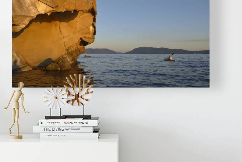 Sea kayaking under sculpted sandstone cliffs by Kevin Oke