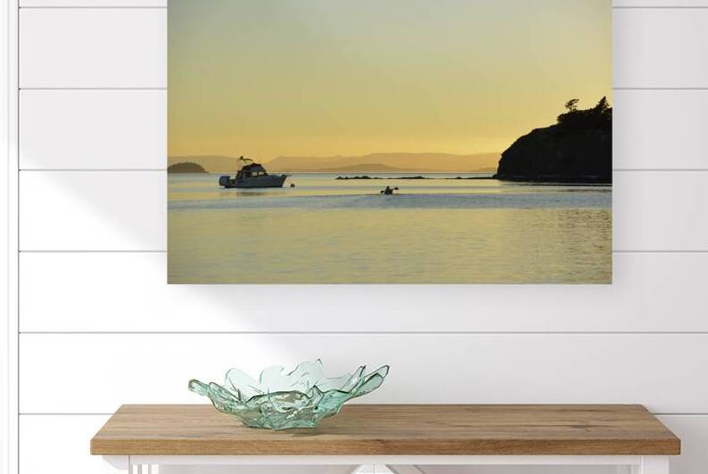 Kayaker and motor boat at anchor in Fox Cove. Sucia Island by Kevin Oke