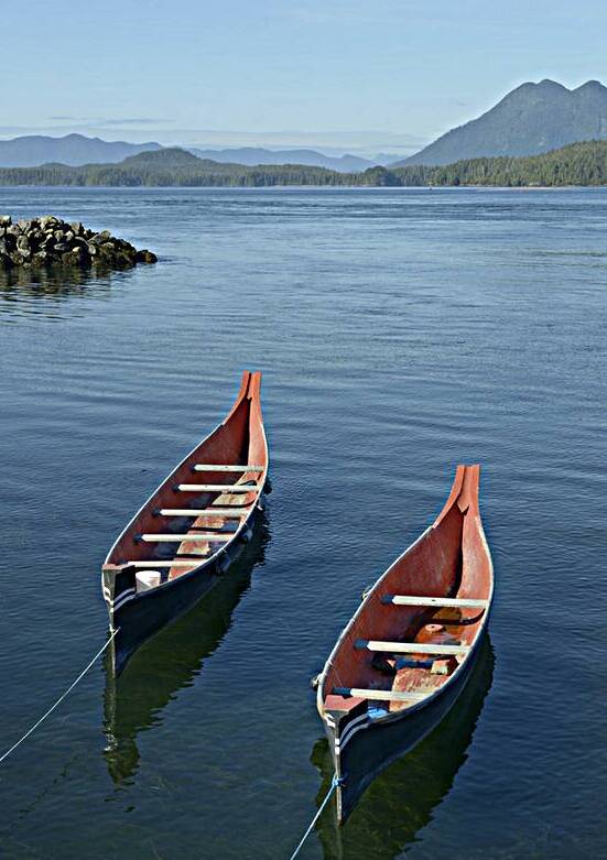 Two native canoes anchored in Tofino Harbour by Kevin Oke